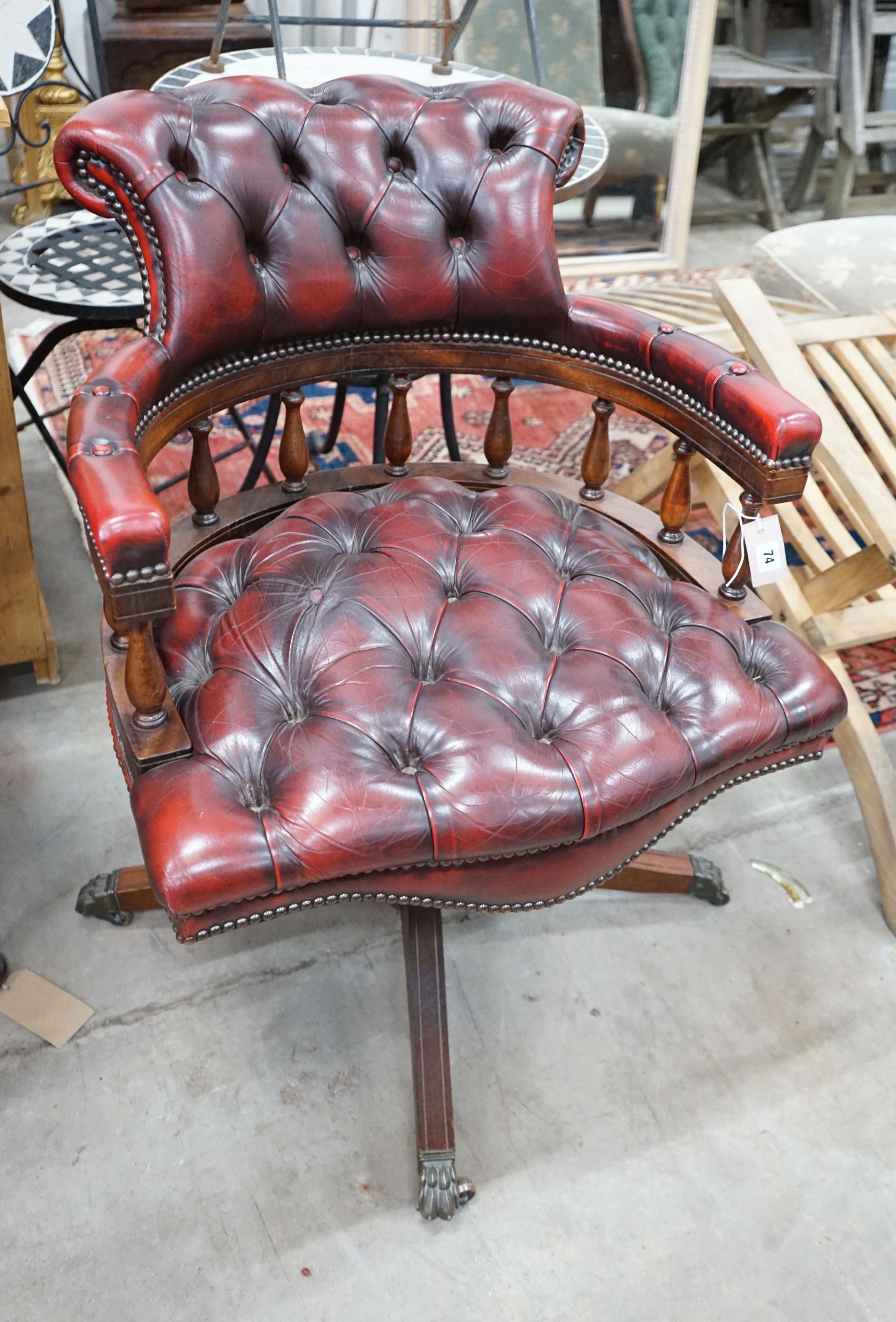 A reproduction Victorian style buttoned red leather upholstered swivel desk chair, width 63cm, depth 59cm, height 84cm